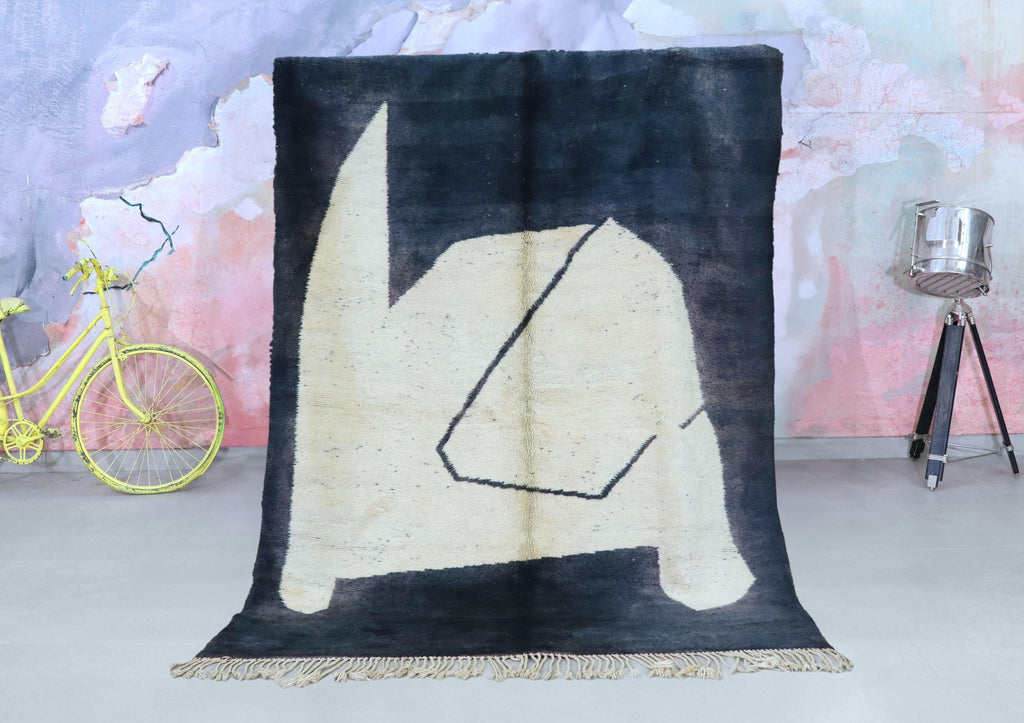 Handwoven black and cream Beni Ourain Moroccan rug with an abstract geometric Berber pattern.
