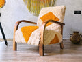 Handcrafted Moroccan mid-century lounge chair with a walnut wood frame and yellow-and-cream checkered wool upholstery in a modern room.